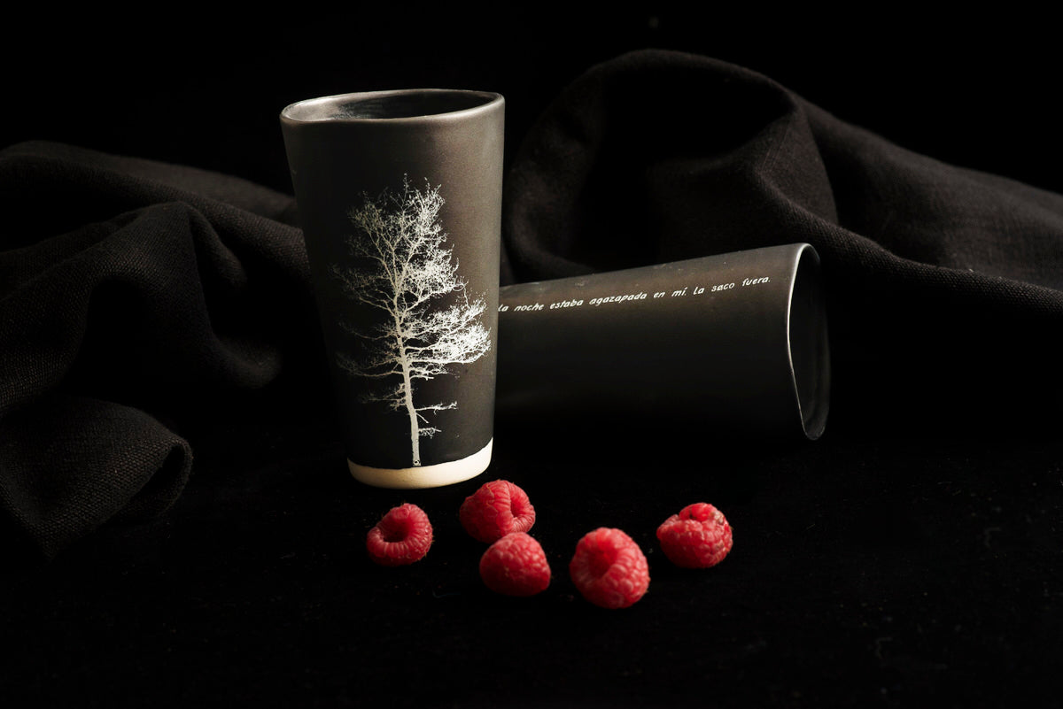 black handmade Adarbakar tumblers with a photograph on one side and a poem on the other