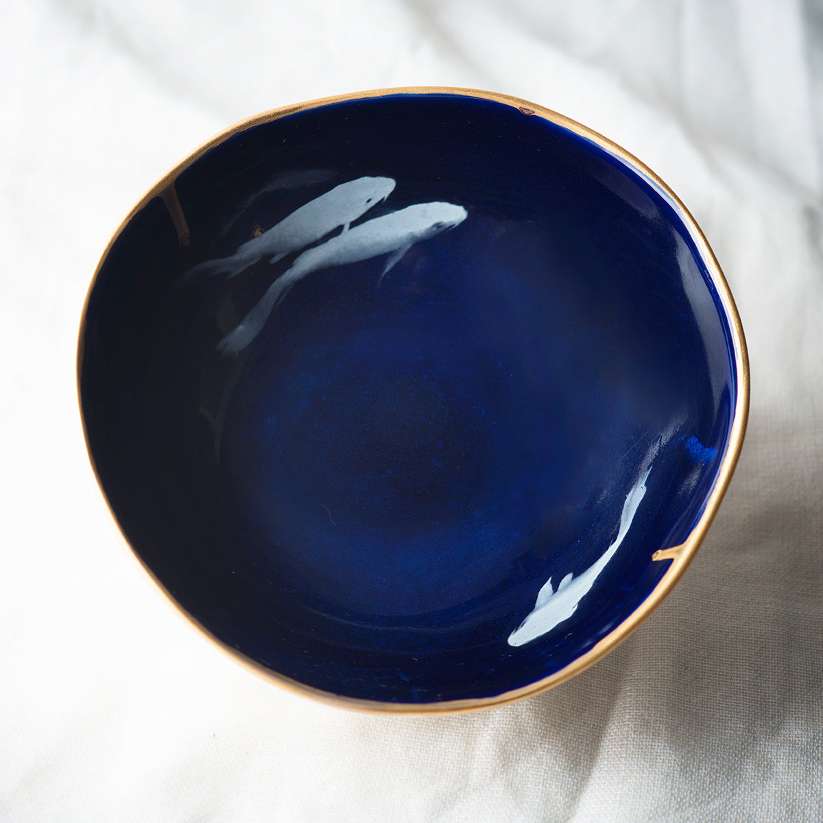 Dark blue cobalt bowl with Koi fish and golden edge.